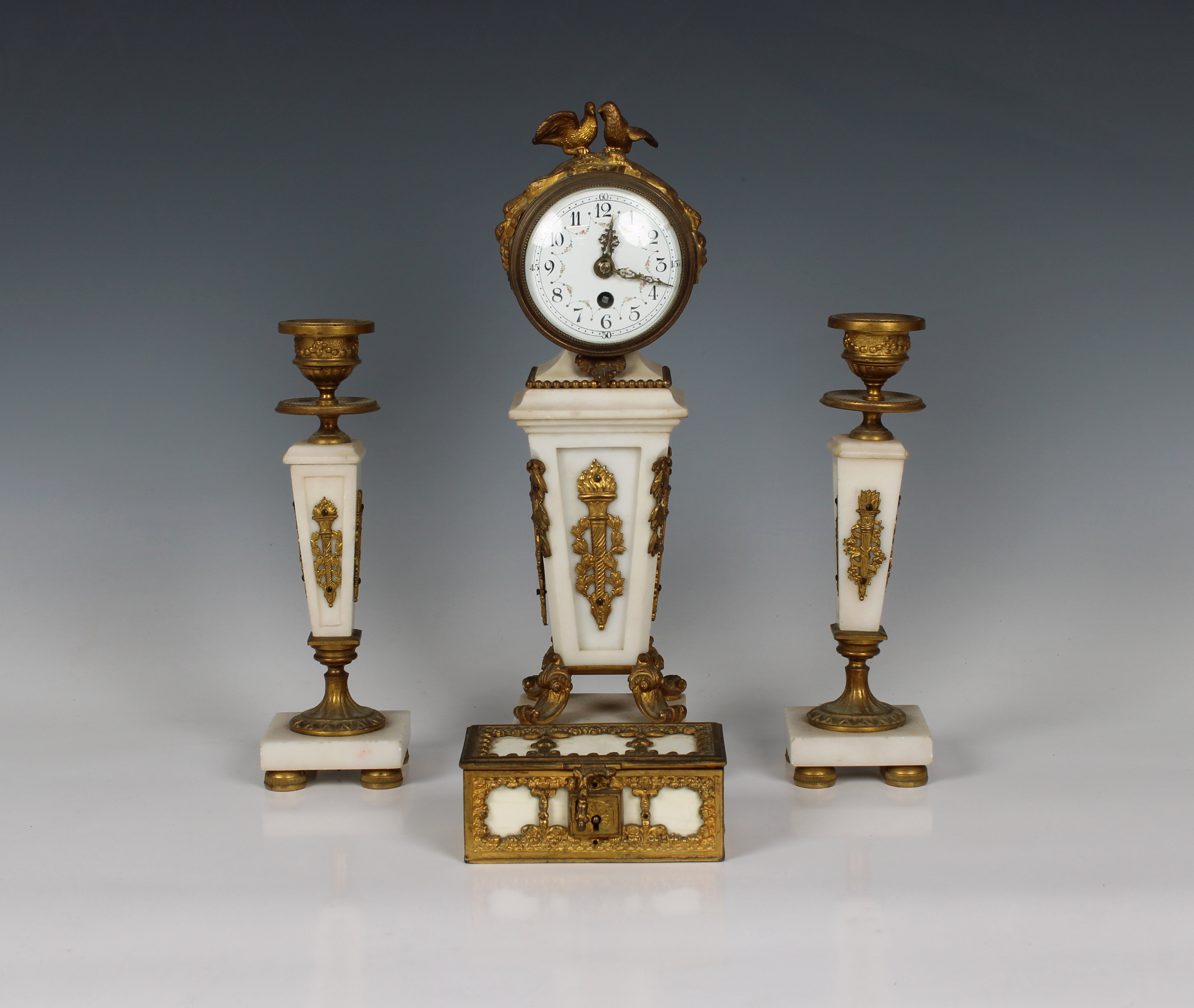 A French late 19th century ormolu and white marble clock garniture