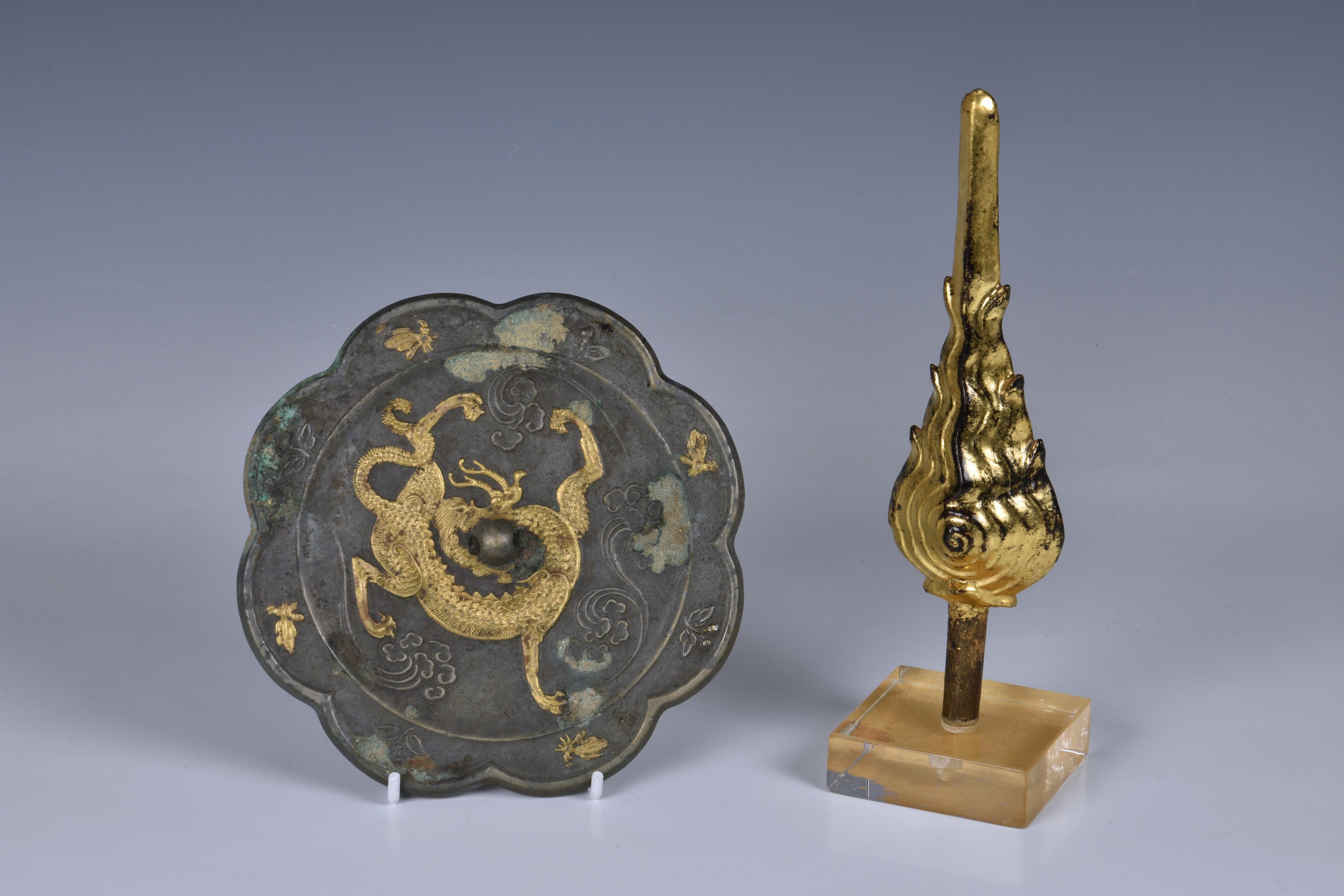 A Chinese Tang Dynasty style bronze and gilt dragon mirror