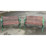 A pair of cast metal and wood slatted garden benches