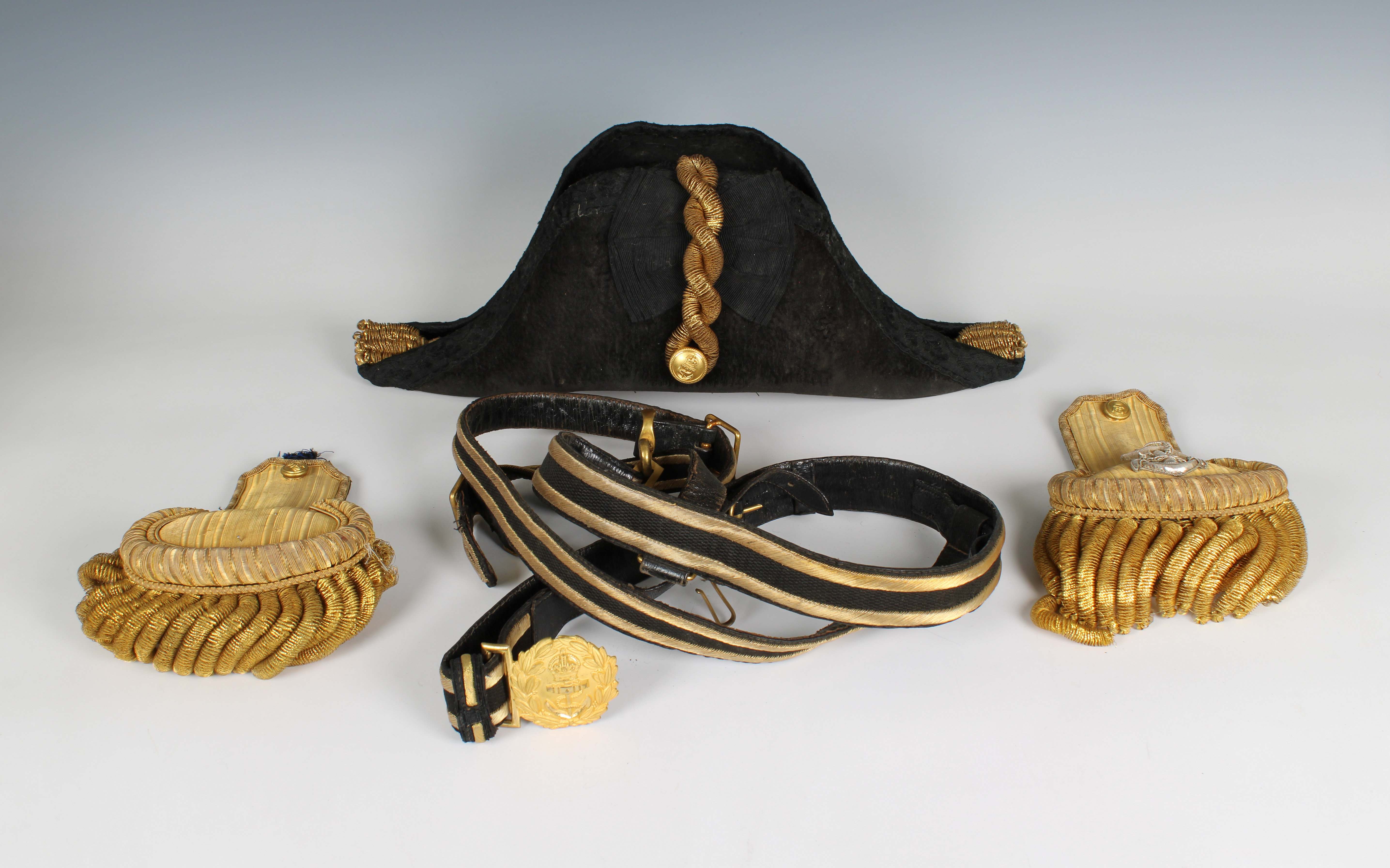 An Edwardian full dress Royal Navy bicorn cocked hat, pair of epaulettes and sword belt