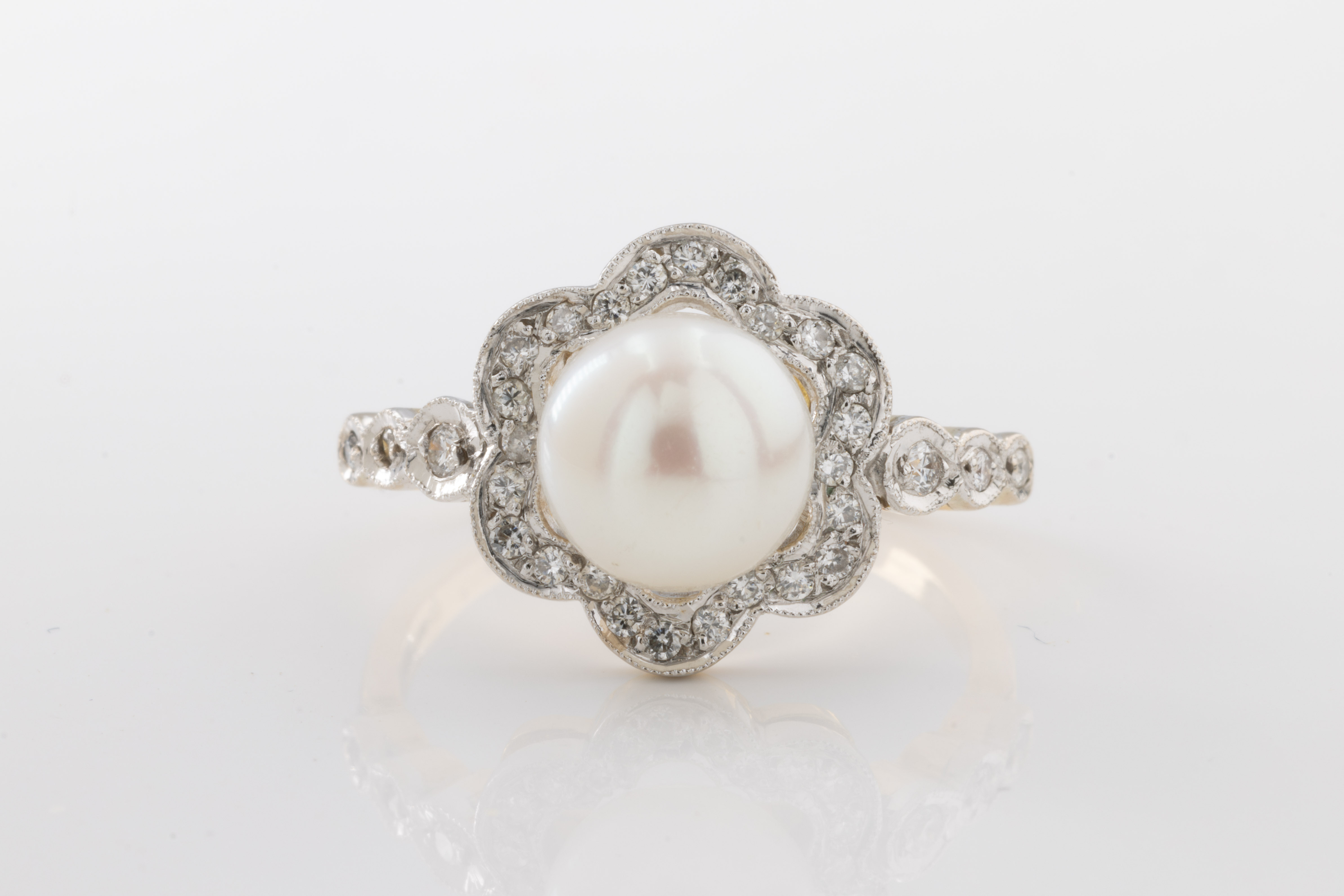 An 18ct yellow gold, pearl and diamond ring