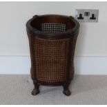 An early 20th Century mahogany and cane waste paper basket