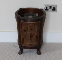 An early 20th Century mahogany and cane waste paper basket