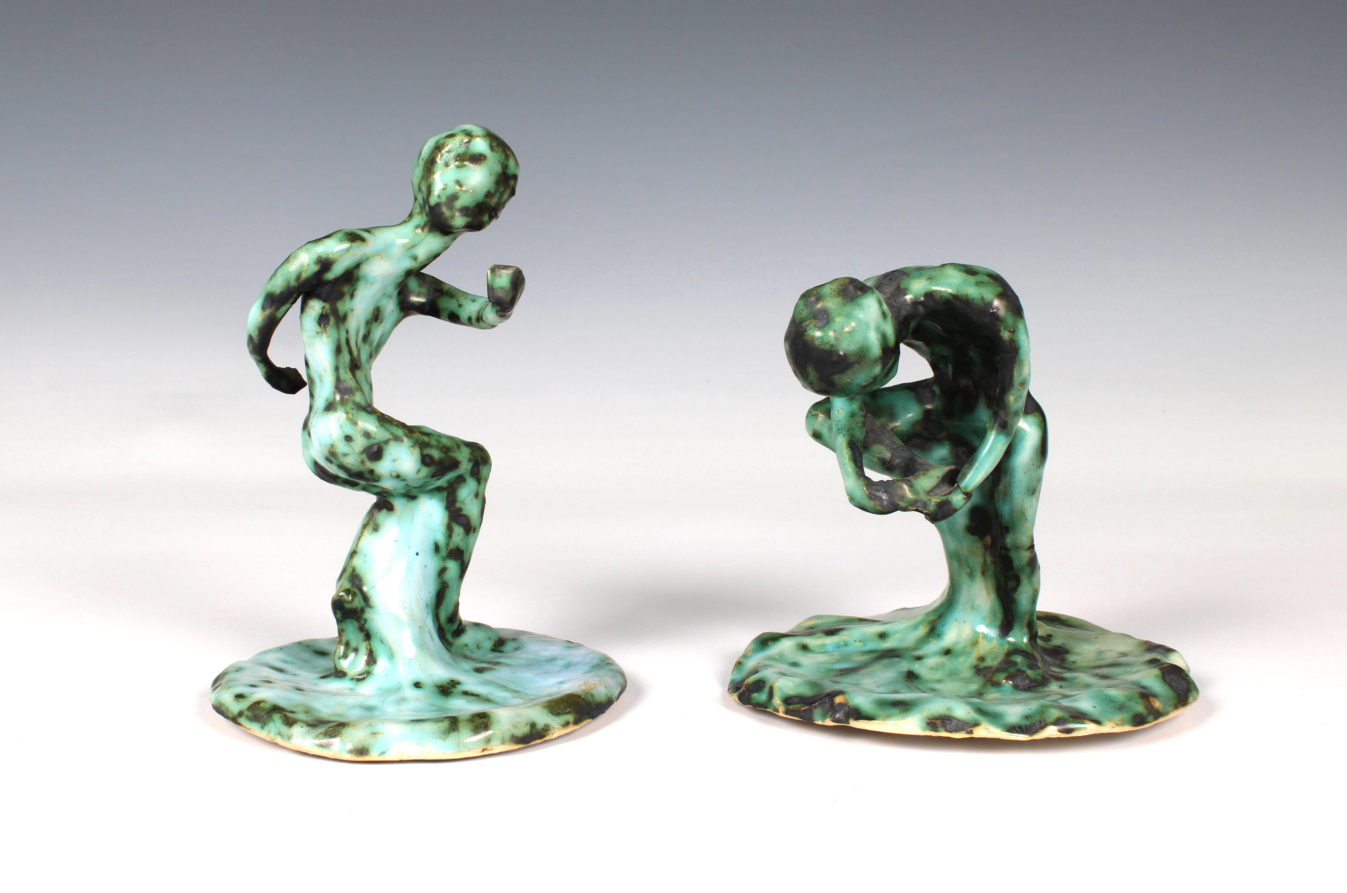 Elizabeth Ann Macphail (1939-89) Two green glazed stylised figural sculptures 'Before & After'
