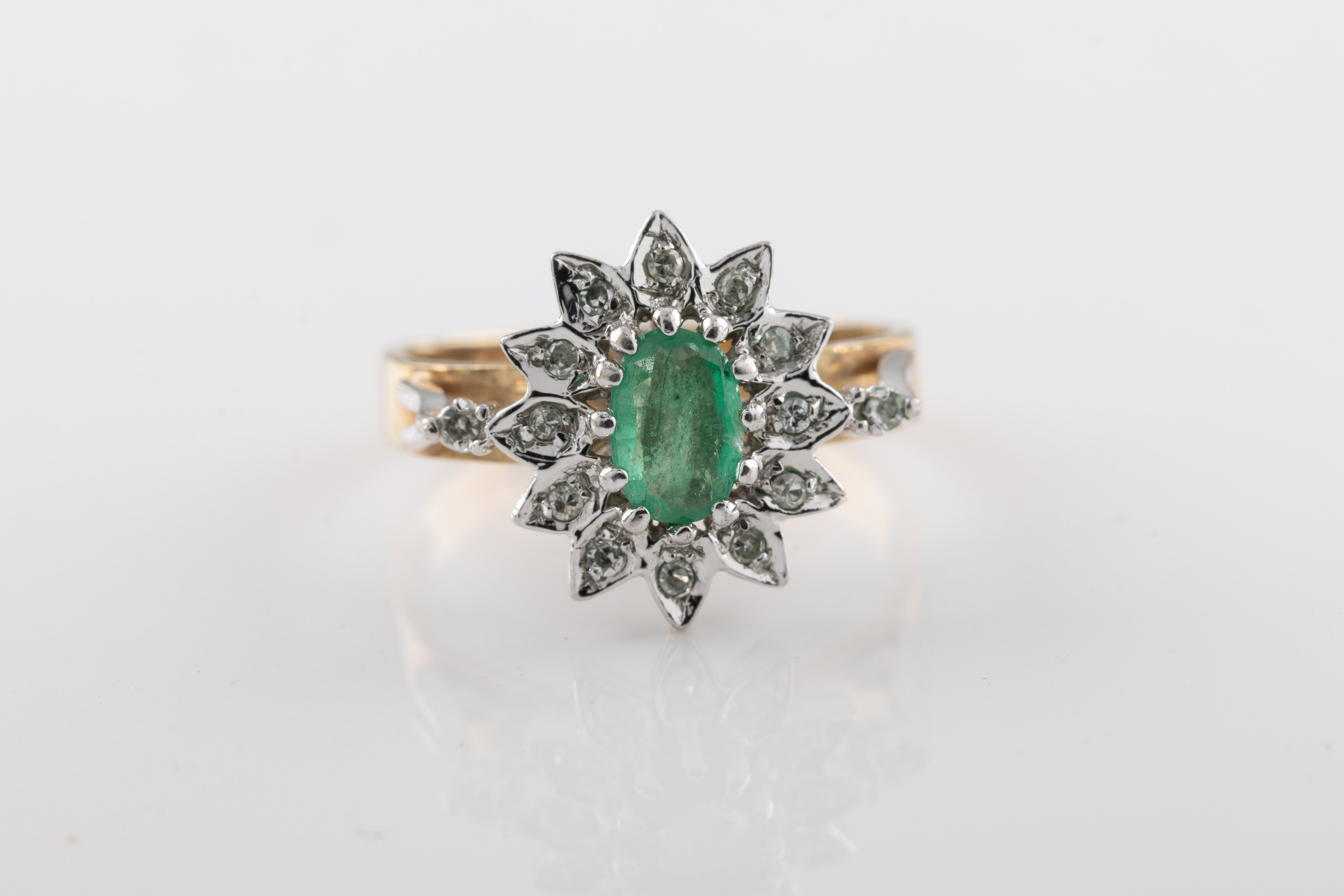 A 9ct yellow gold, emerald and diamond cluster ring