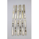 A set of six Asprey silver-gilt fruit knives and forks with mother-of-pearl handles