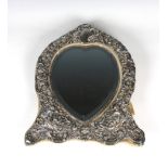A late Victorian heart shaped silver dressing table mirror of large proportions