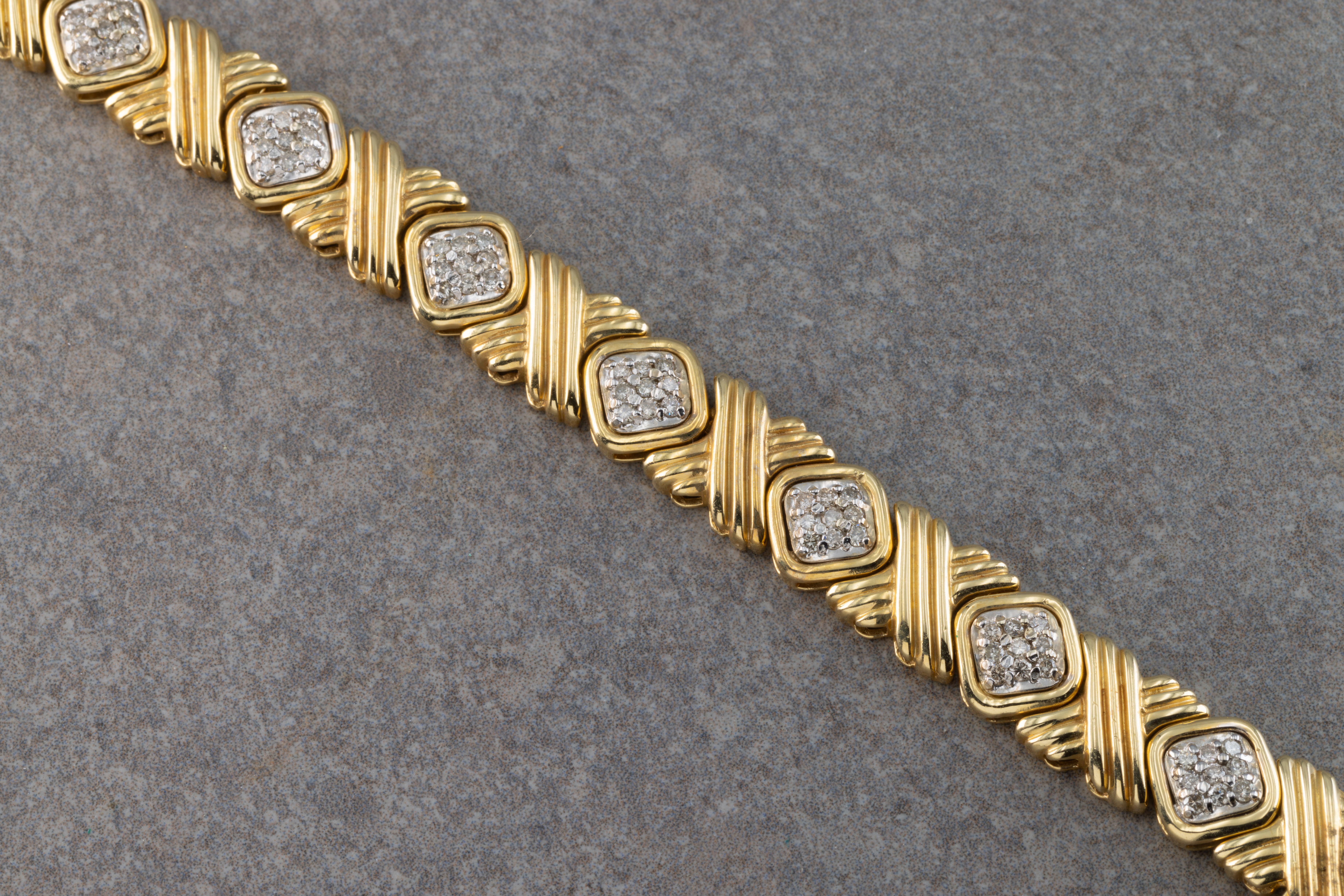 A 14ct yellow and white gold diamond bracelet