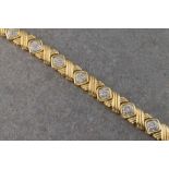 A 14ct yellow and white gold diamond bracelet