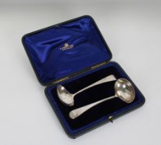 A pair of George III silver feather pattern sauce ladles