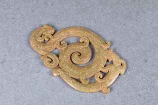 A large Chinese carved celadon, ochre and straw mottled jade plaque