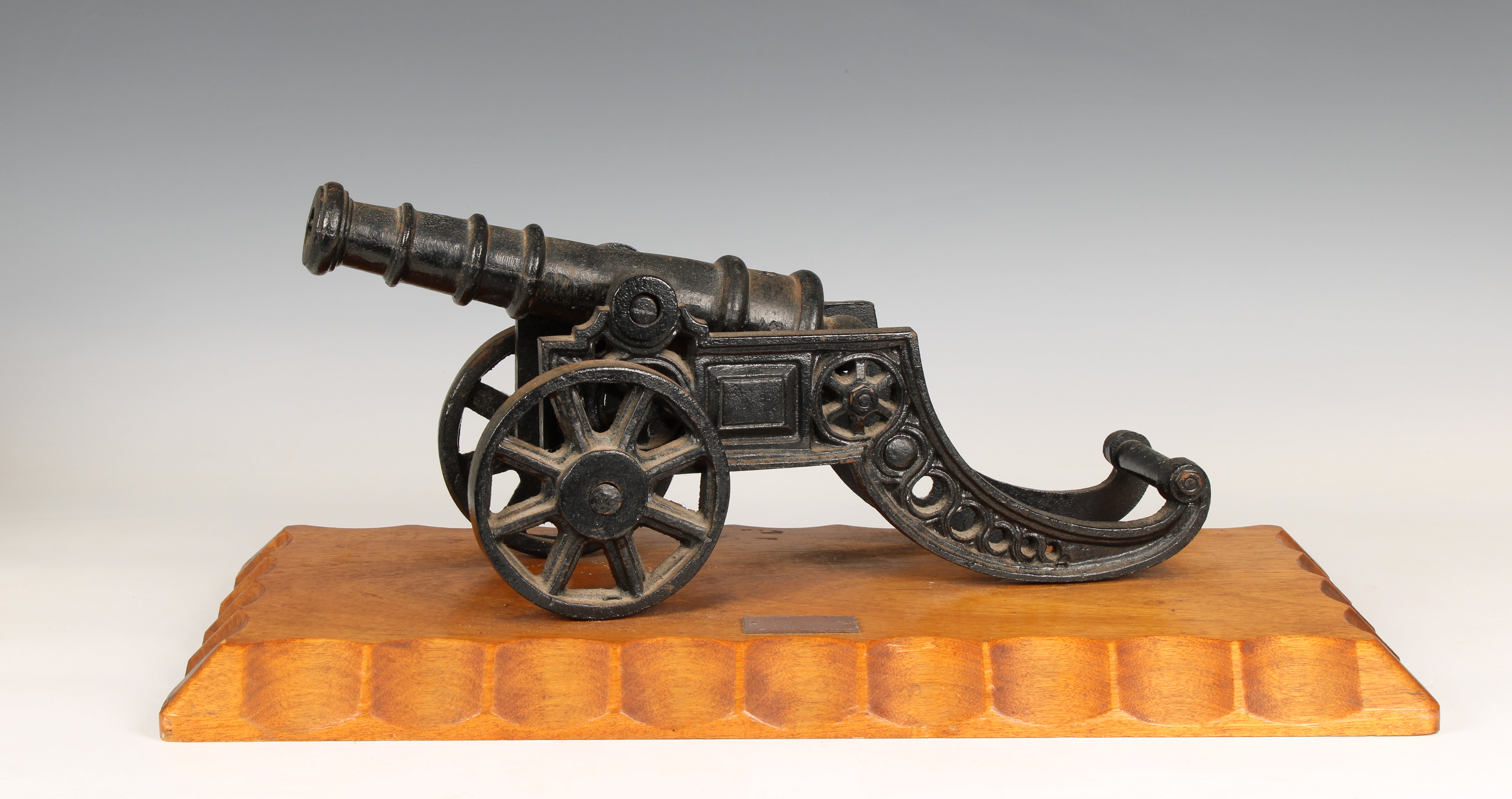 A model cannon with an iron barrel and iron two wheeled gun carriage