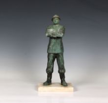 A French patinated bronze figure of a fireman with a silvered bronze helmet