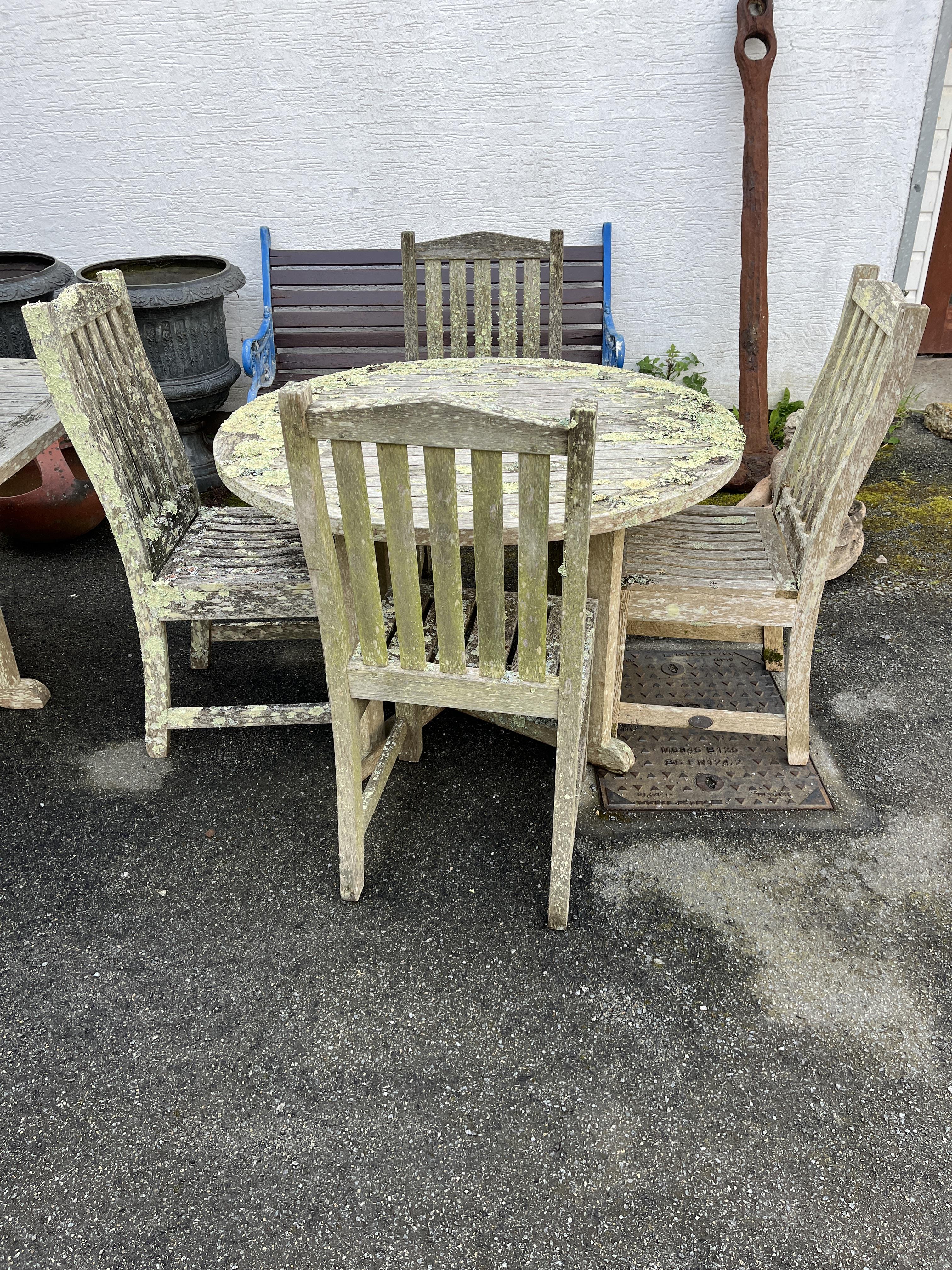 A circular teak table with four chairs