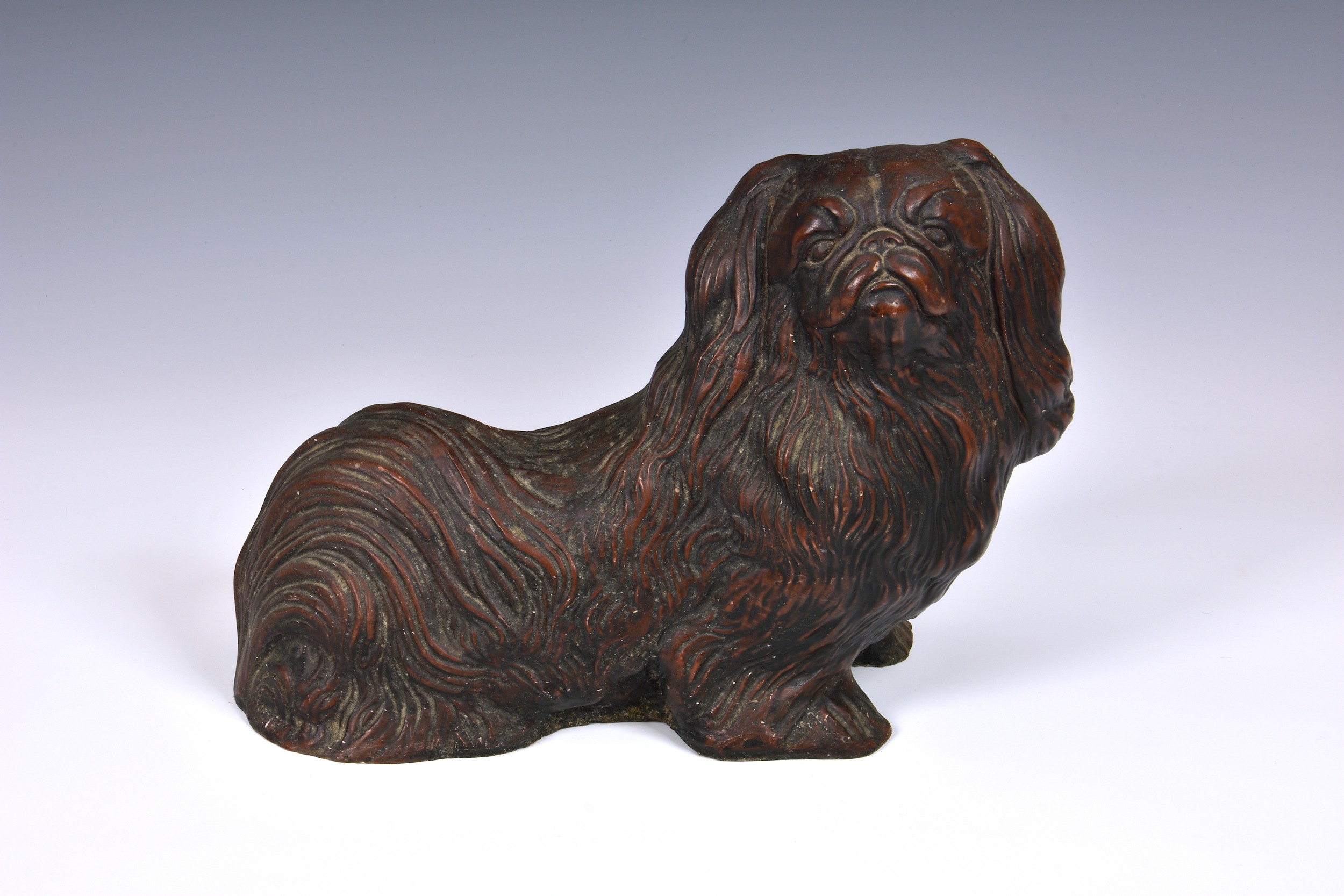 A Pekingese dog figure or doorstop