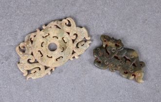 A Chinese celadon jade reticulated dragon disc