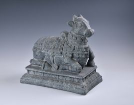A painted papier-mache, faux-granite figure of Nandi, the Hindu sacred cow