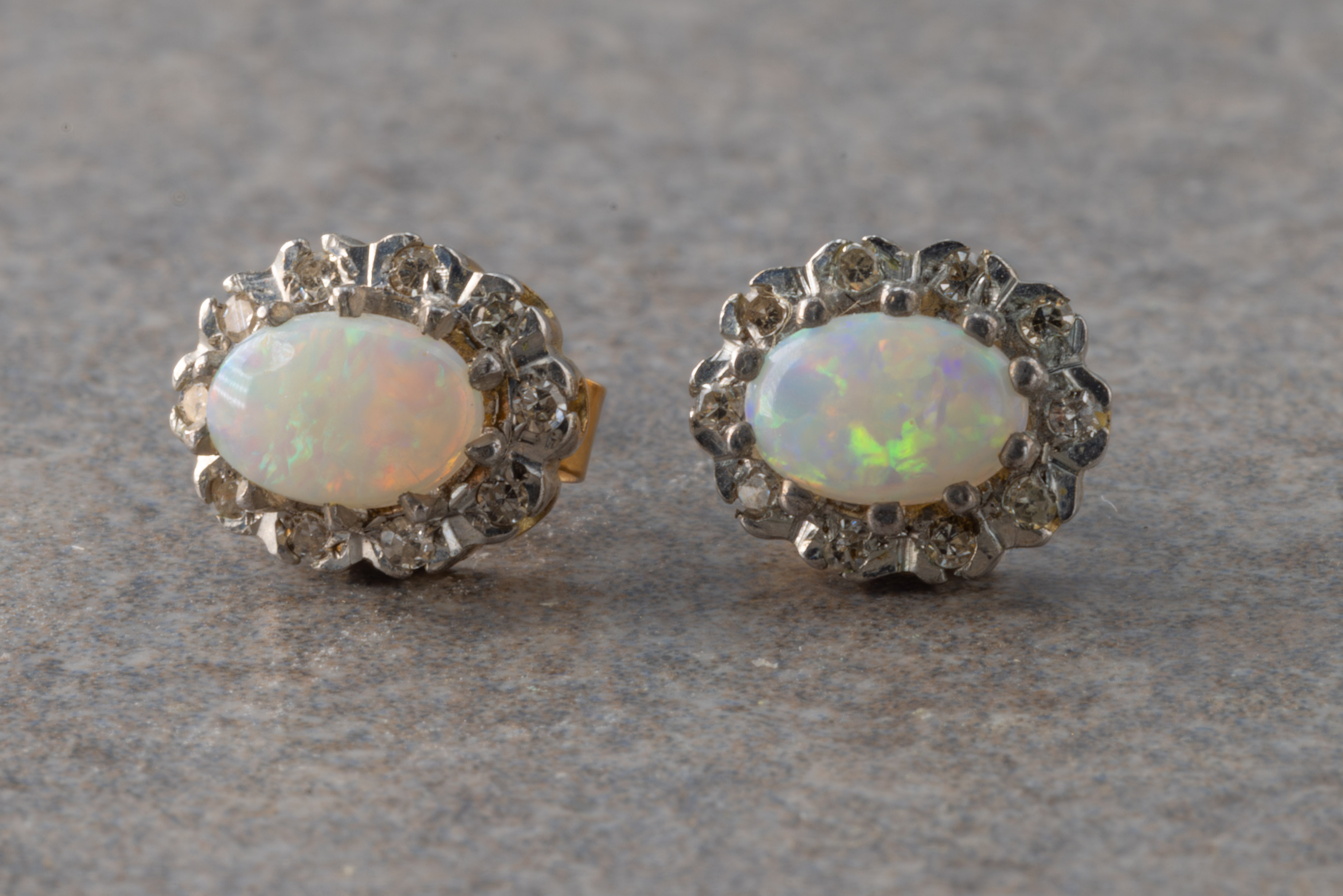 A pair of opal and diamond earrings