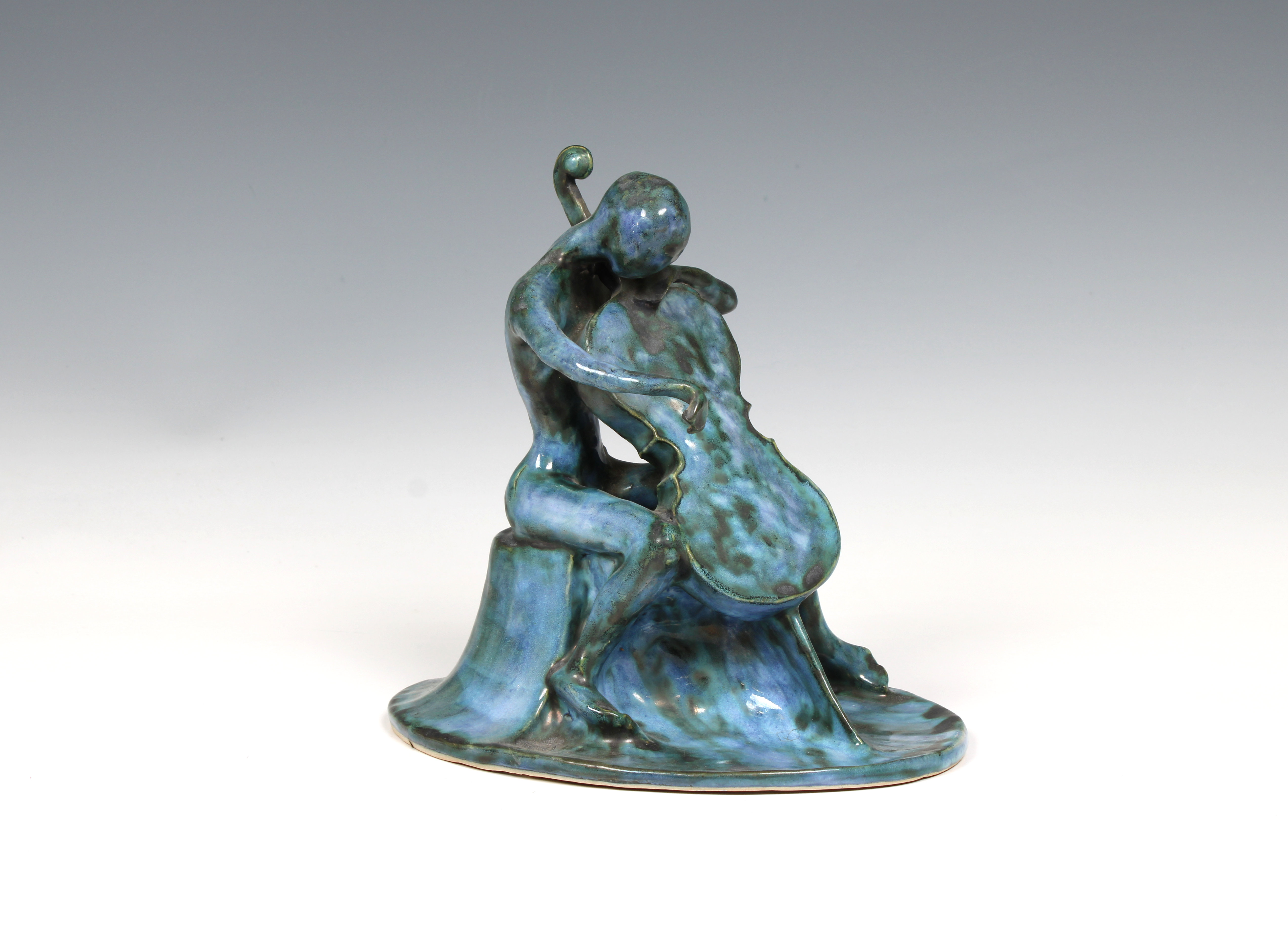 Elizabeth Ann Macphail (1939-89) A turquoise glazed stylised cellist or double bass player sculpture