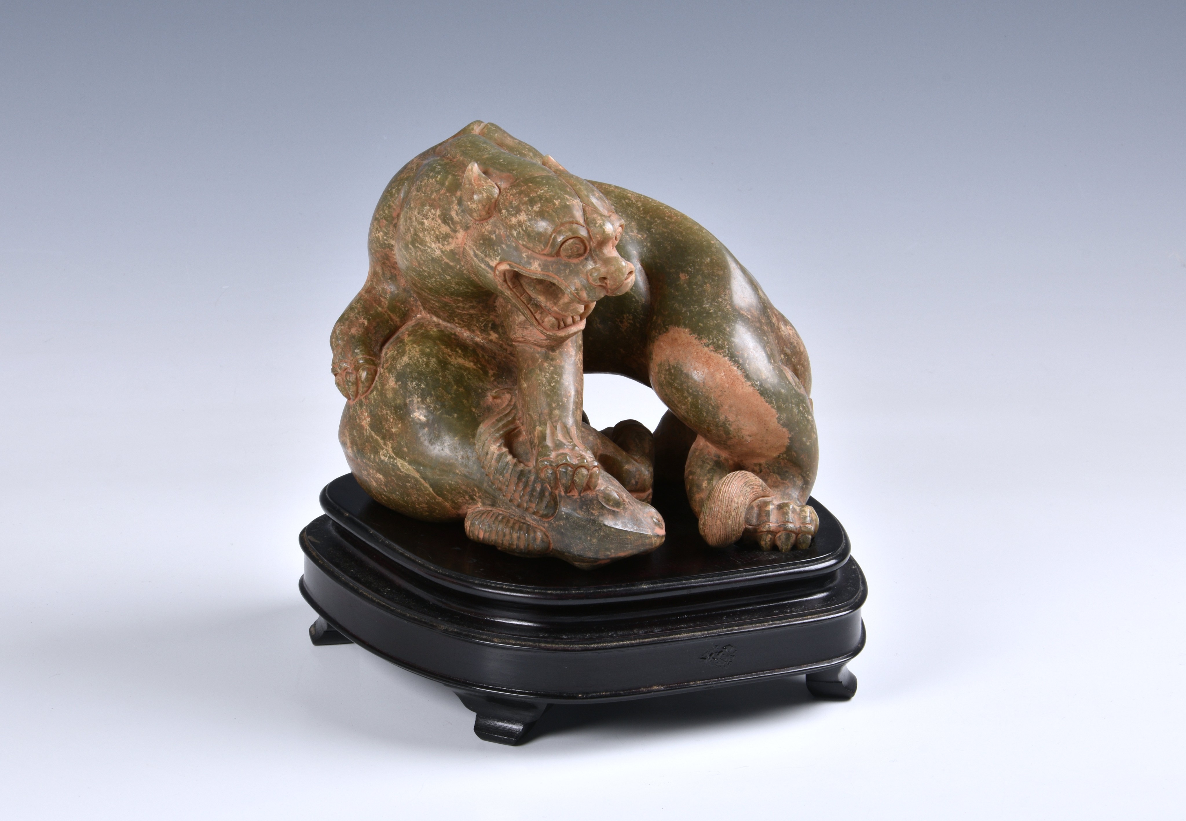 A Chinese carved celadon jade figure of a jaguar and ram