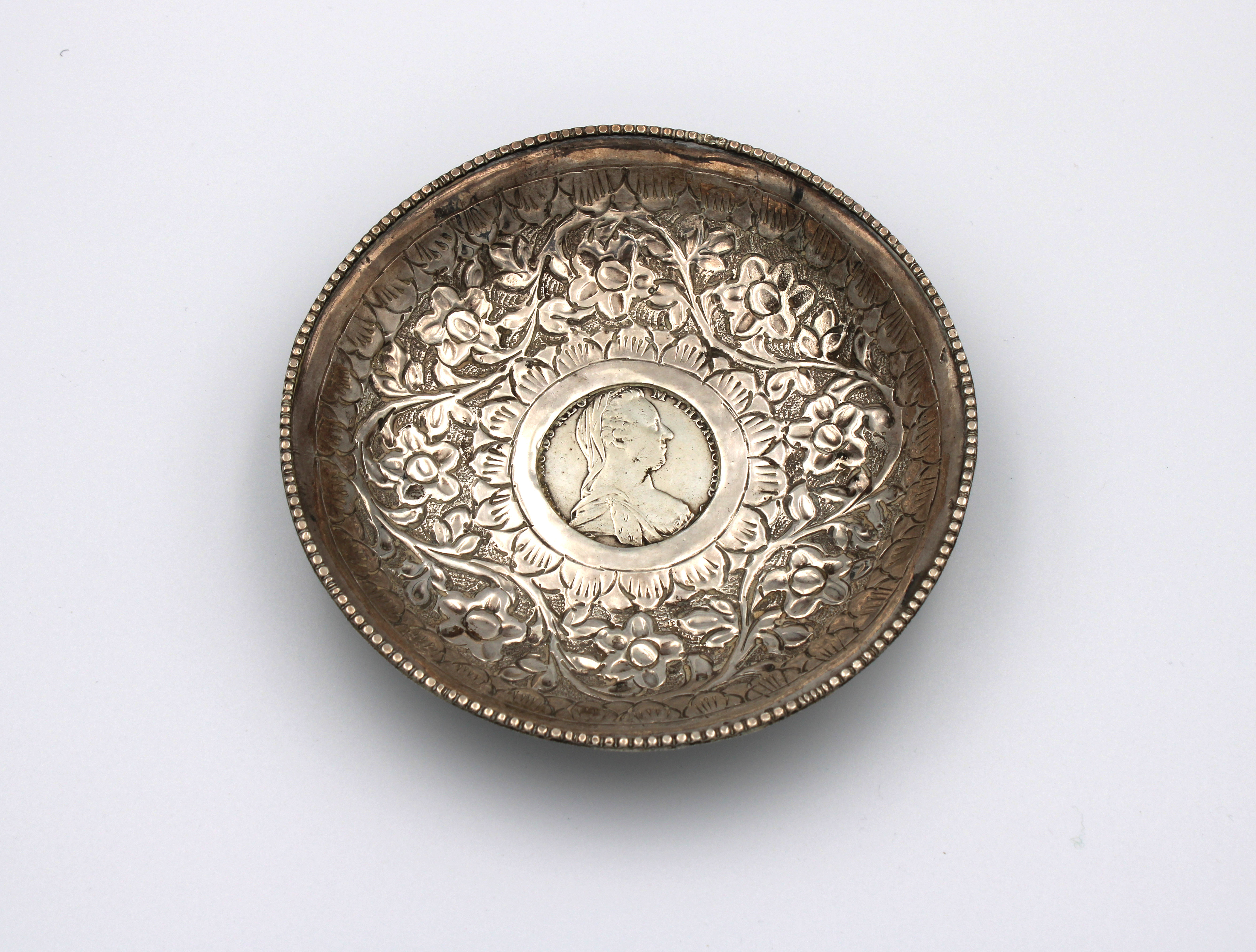 A silver bowl inset with a silver 1780 Maria Theresa Thaler coin