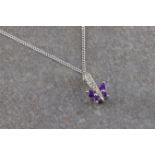 A diamond and amethyst butterfly necklace