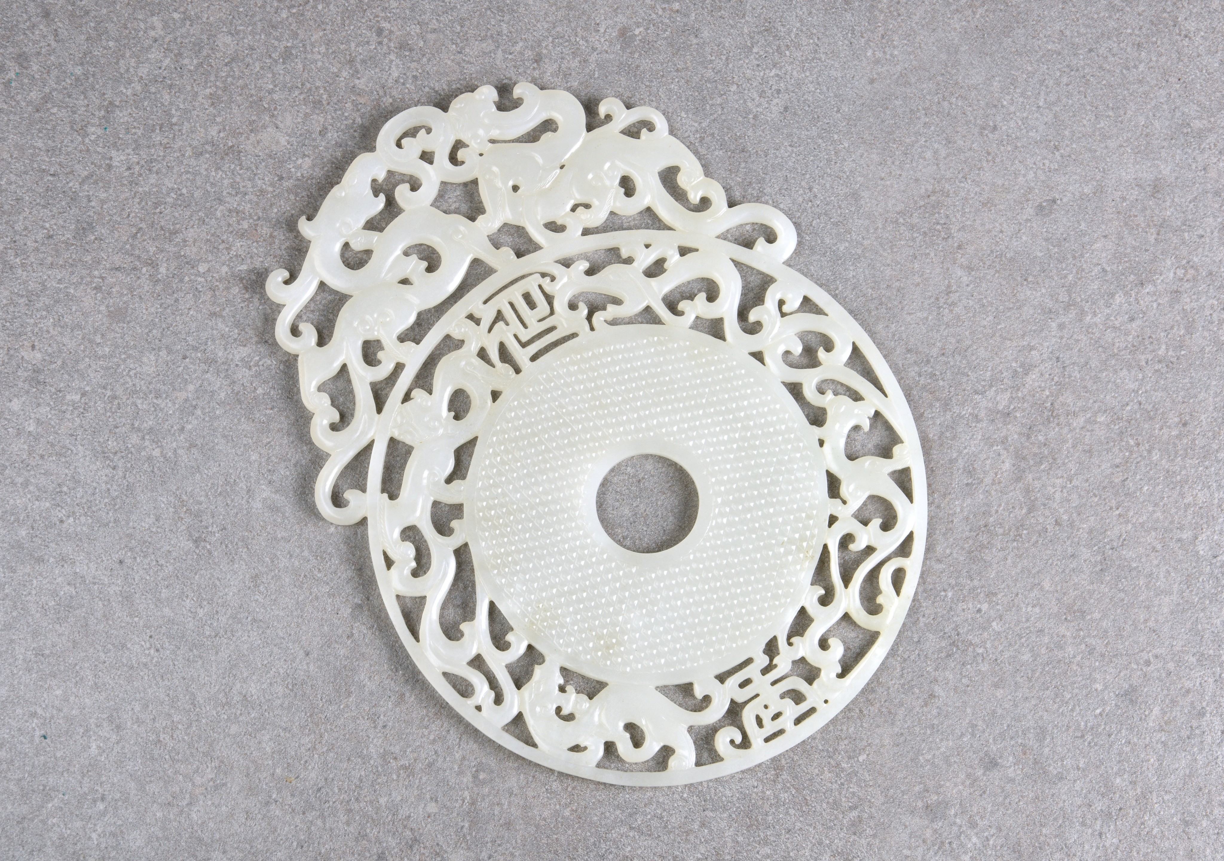 A large Chinese white jade dragon disc