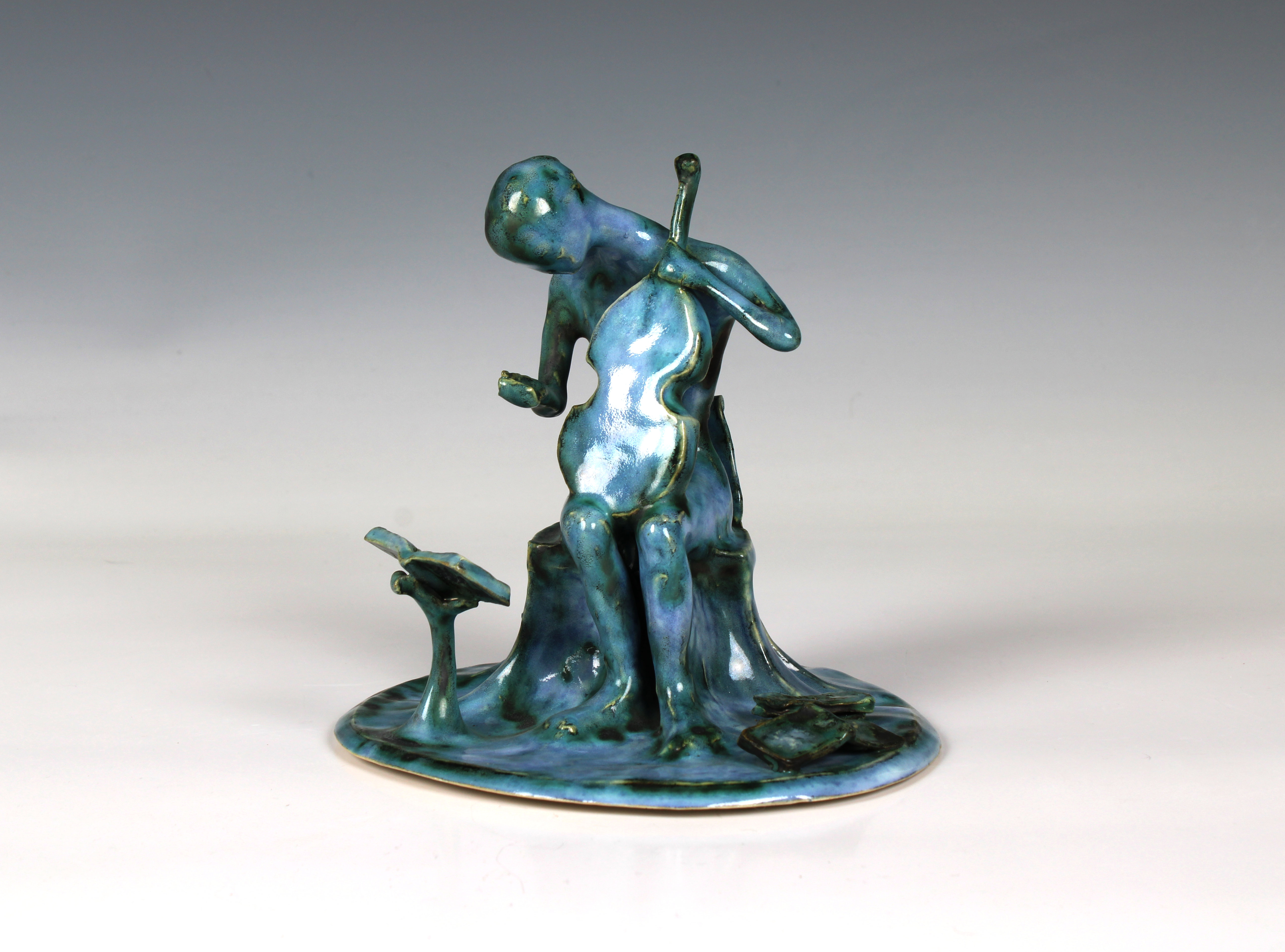 Elizabeth Ann Macphail (1939-89) A turquoise glazed stylised cellist or violin player sculpture