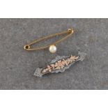 A 9ct yellow gold bar brooch set with a single pearl
