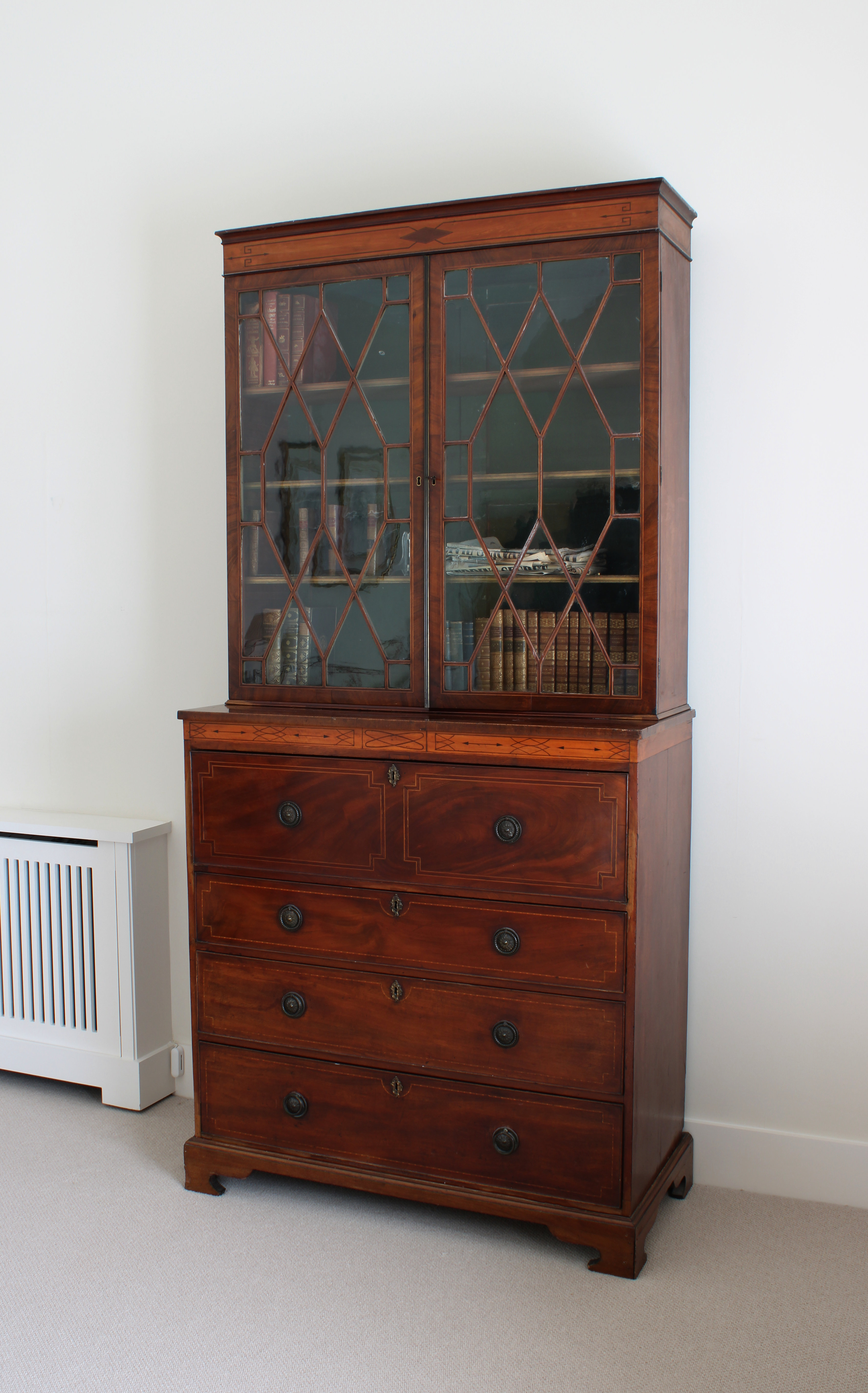 A Regency inlaid mahogany and satinwood secretaire bookcase