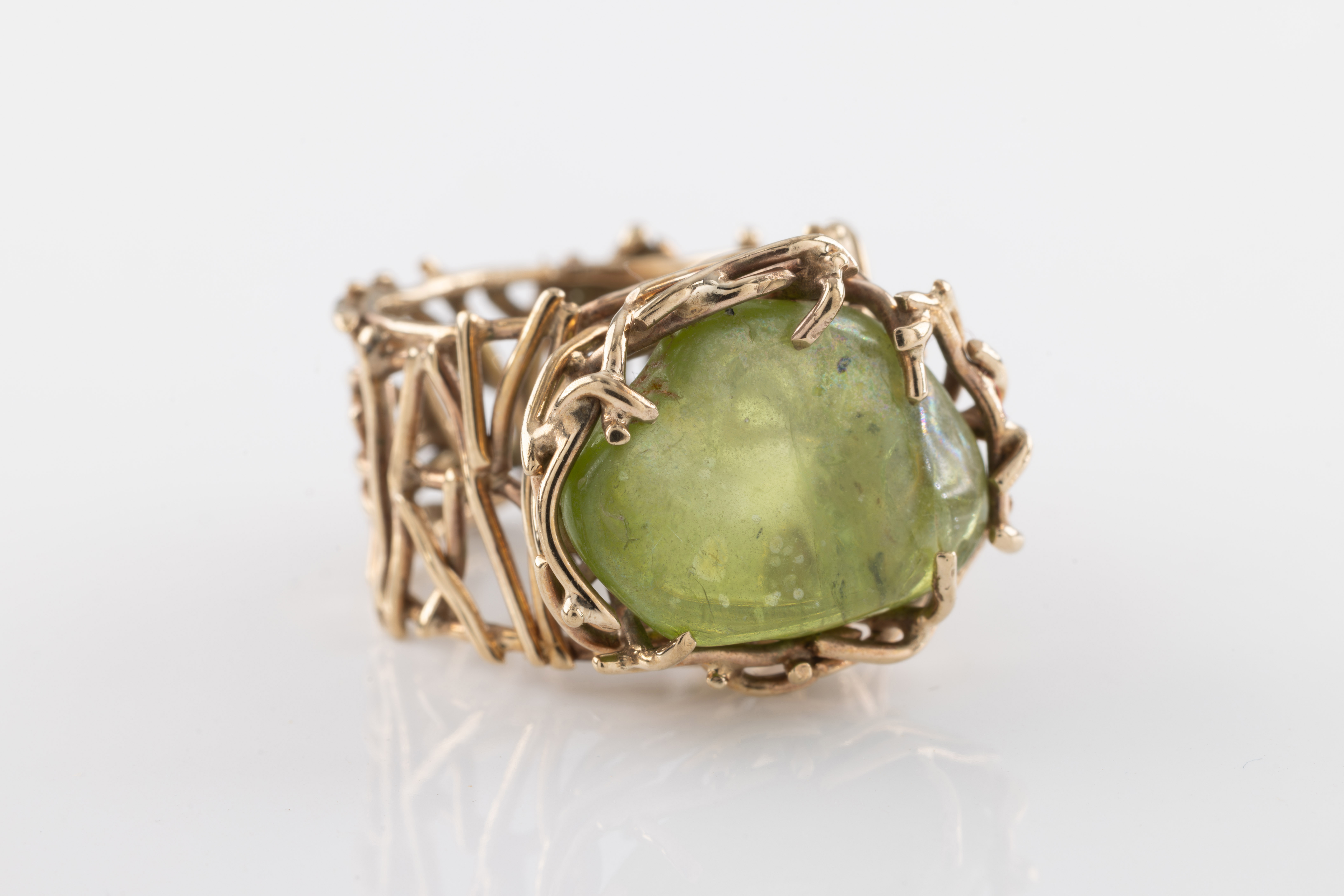 A green stone and yellow metal ring