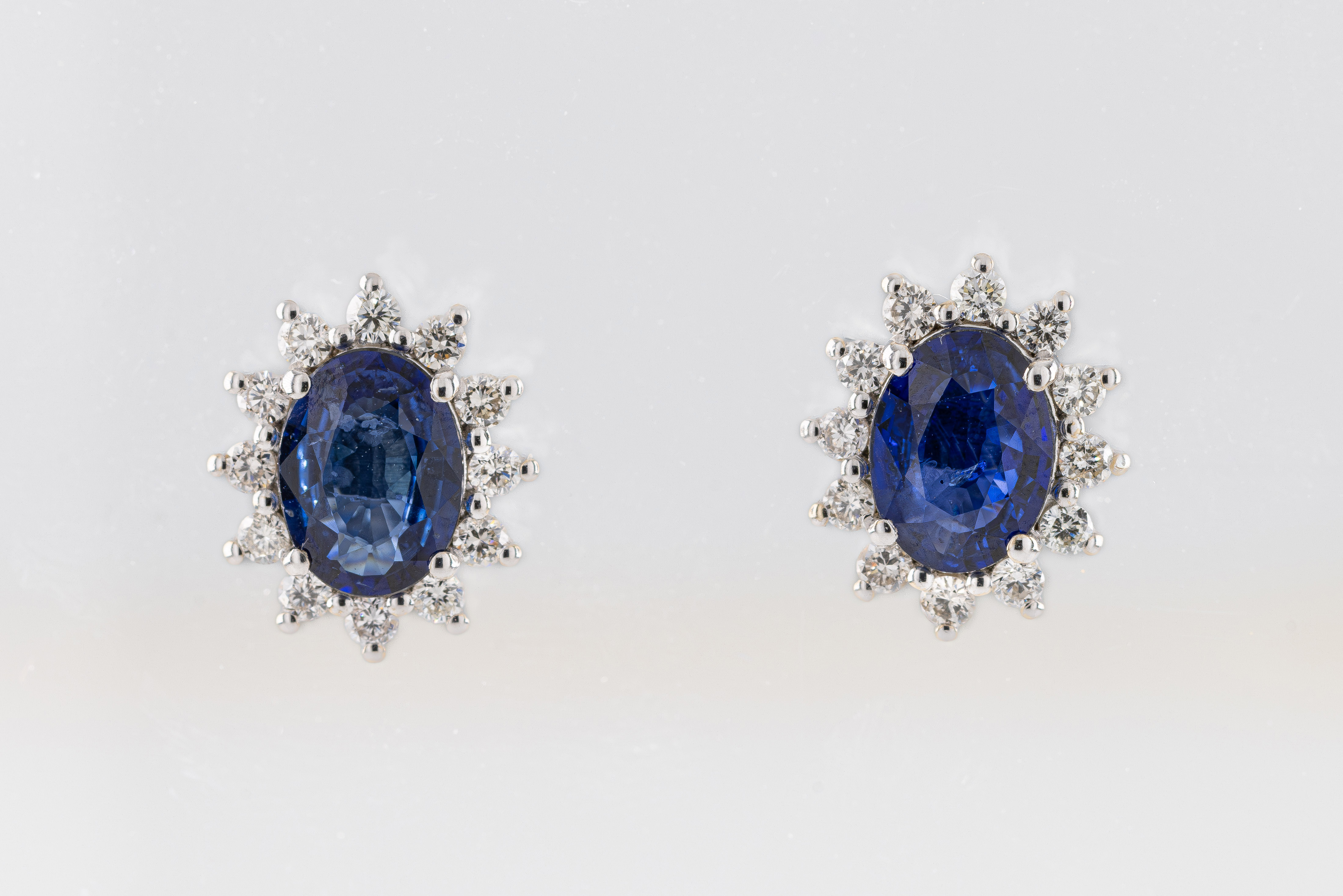 A pair of sapphire and diamond cluster earrings