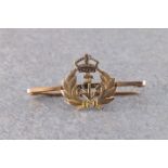 A 9ct gold Royal Navy bar brooch of a crown, anchor and laurel design