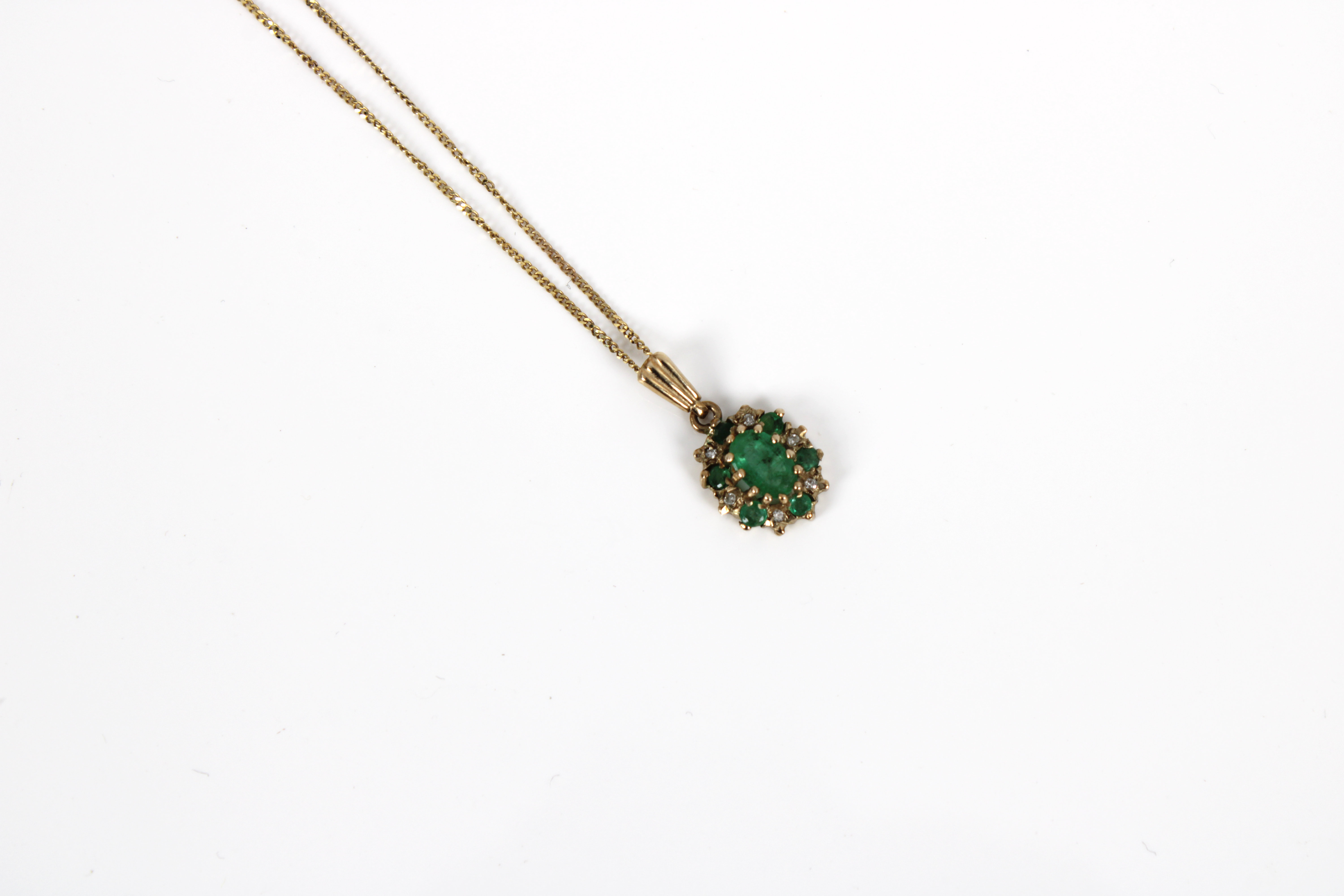 A 9ct yellow gold emerald and diamond cluster pendant