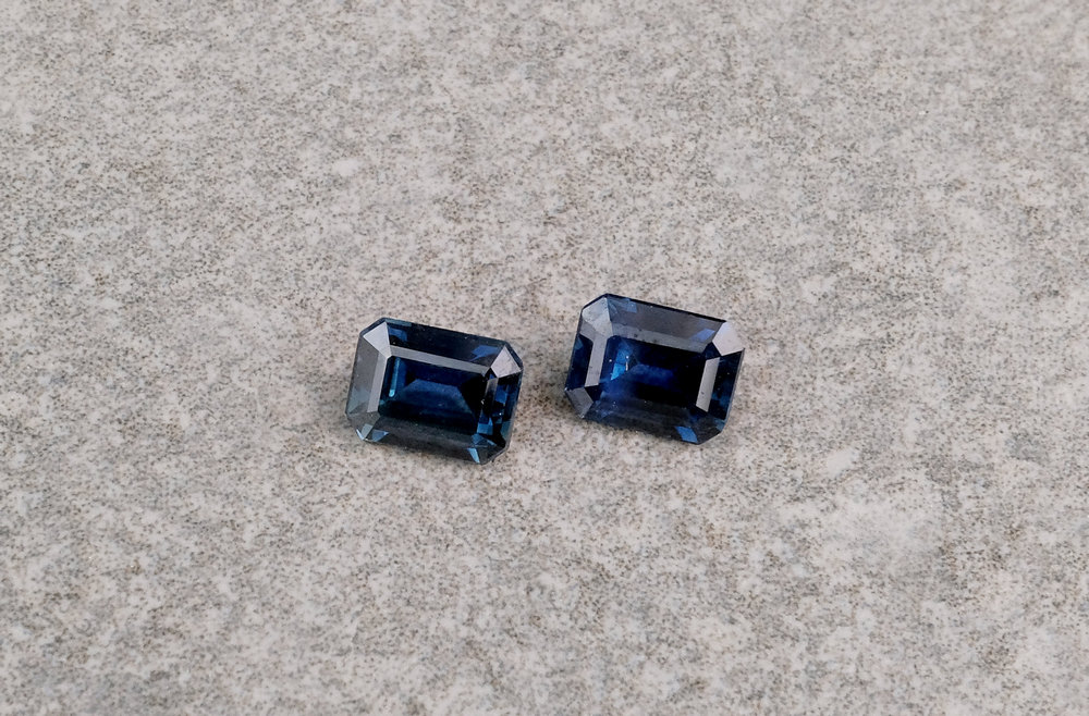 A loose pair of emerald cut blue sapphires