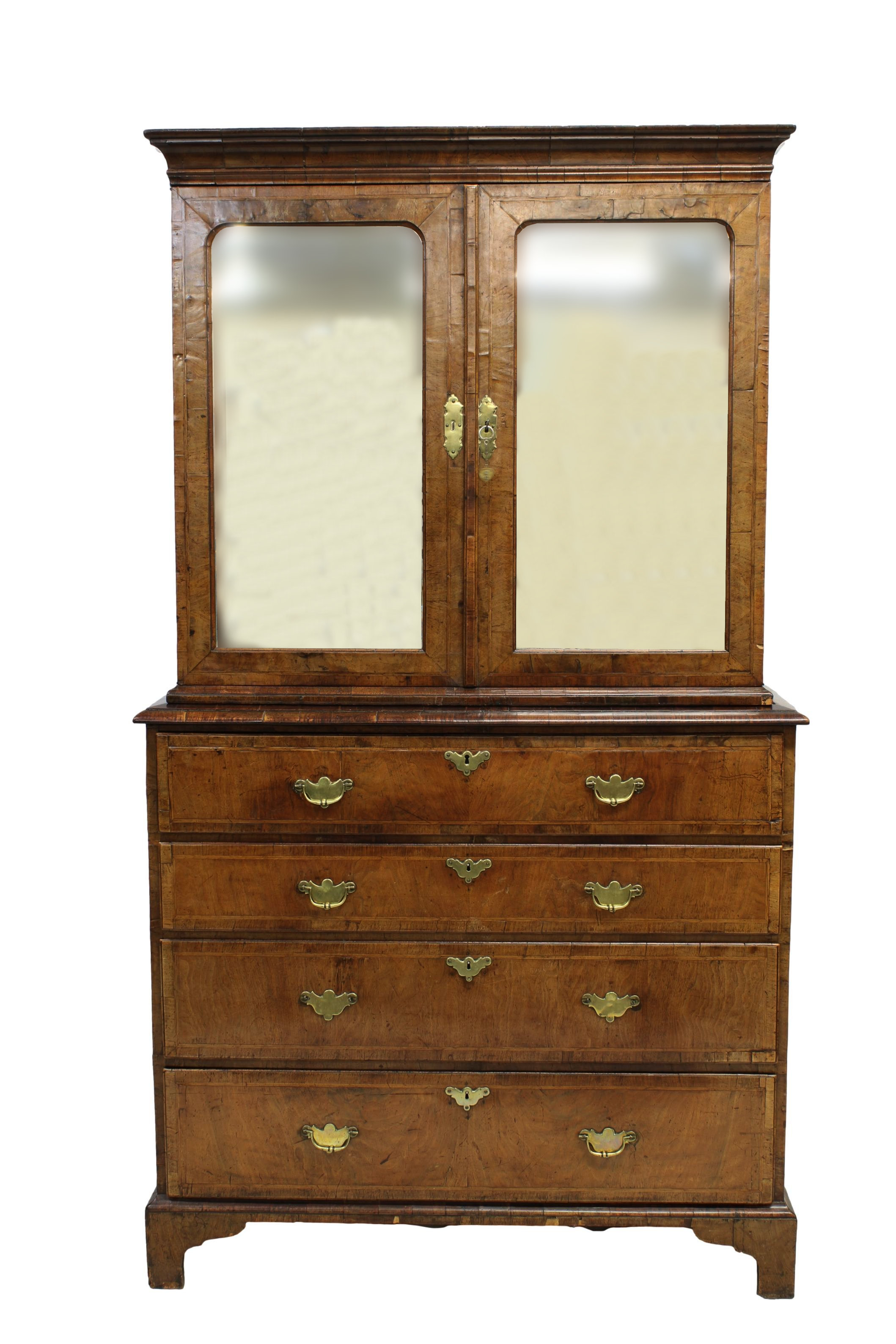 A fine George I walnut secretaire cabinet on chest, upper section with laburnum interior
