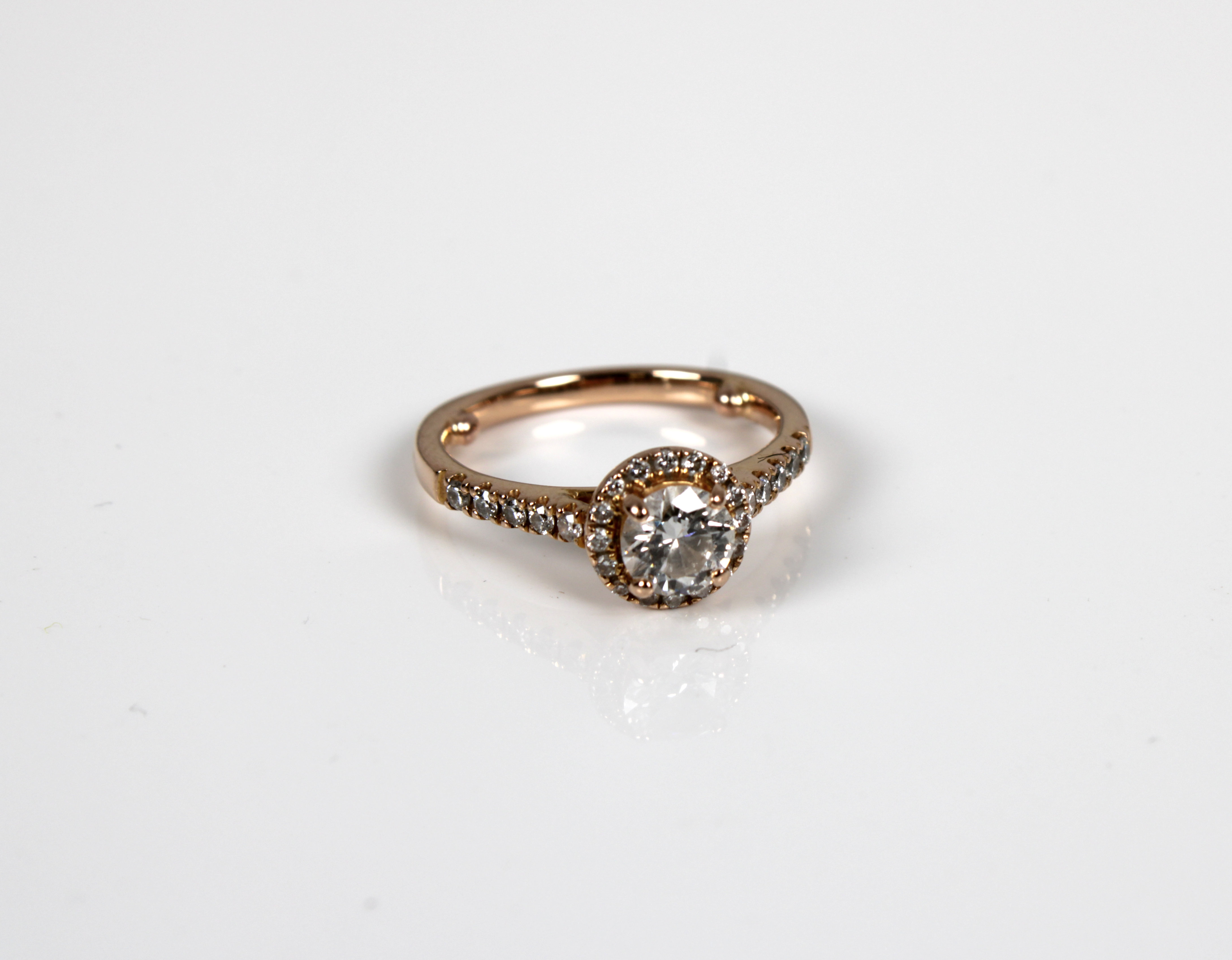 An 18ct rose gold diamond halo ring