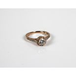 An 18ct rose gold diamond halo ring