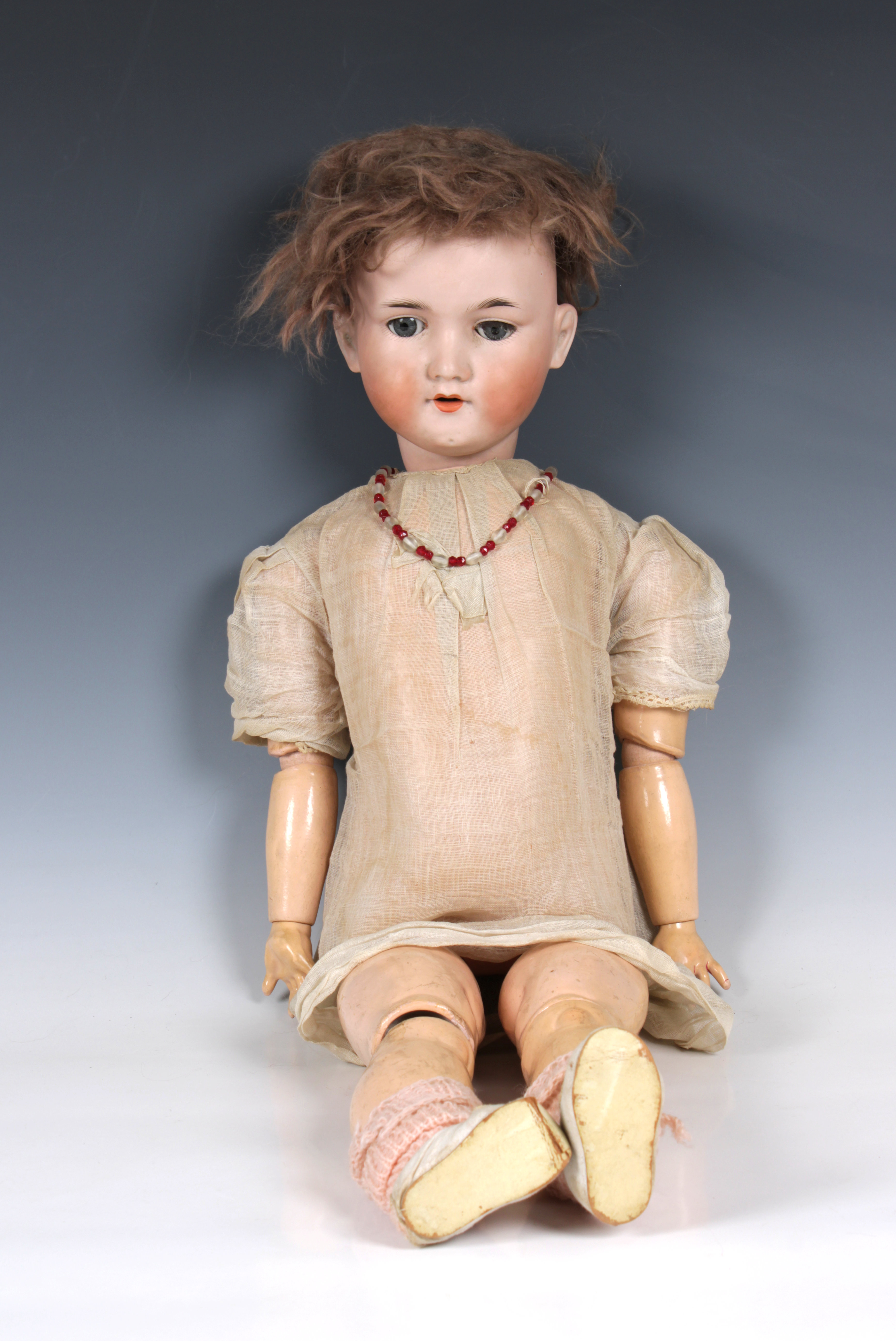 A large antique French Armand Marseilles 390 doll with articulated jointed limbs, paperweight eyes,