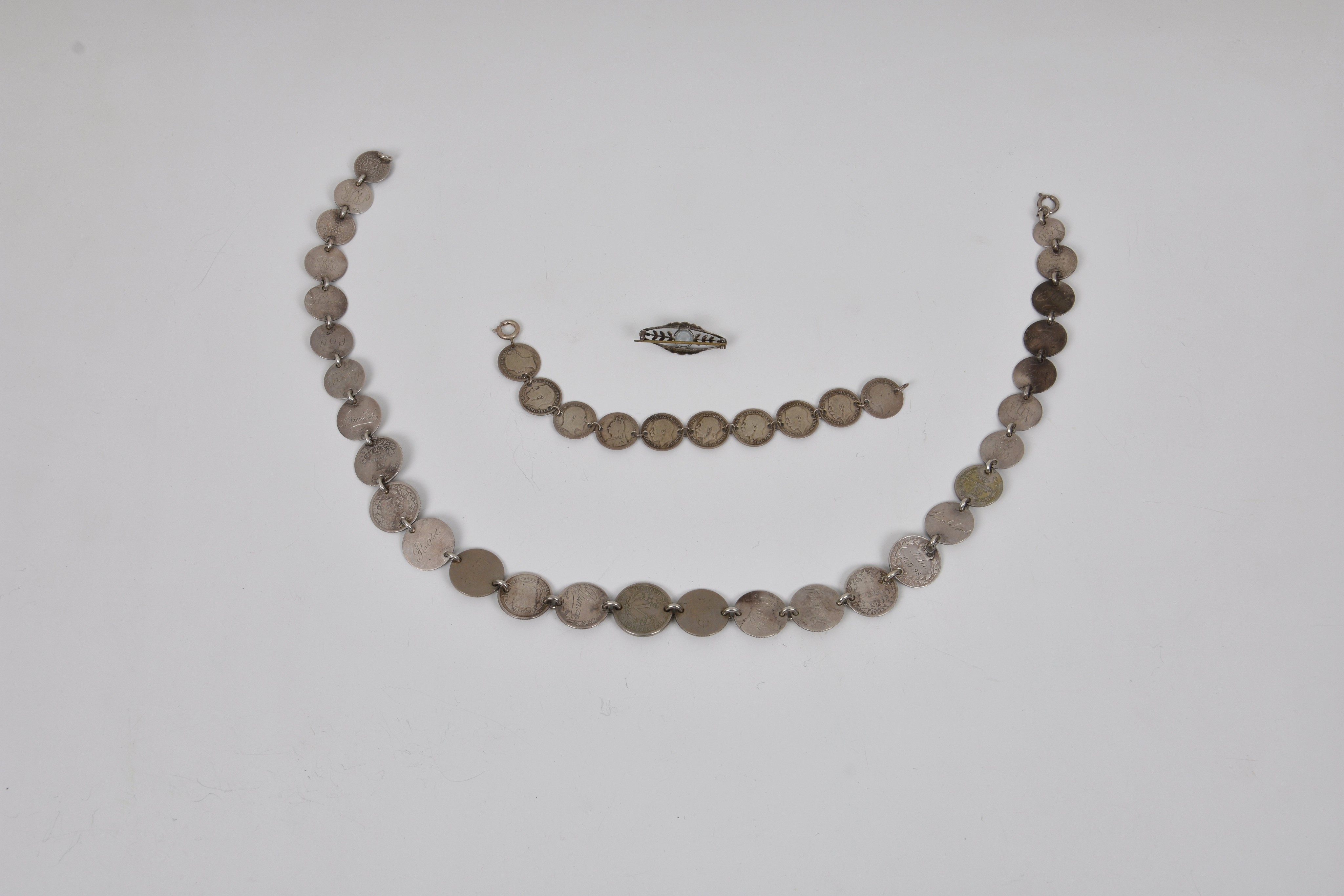 A silver coin necklace and braceletthe necklace made up of twenty nine various graduated silver