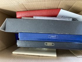 Small box of various coins and coin packs, including 2008 and 2005 proof sets,