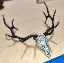 A miniature bronze sculpture of a deer skull and antlers, signed to base F Boyer, width 12cm