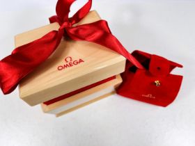 An OMEGA presentation box in polished wood with red plush lining, c. 2000