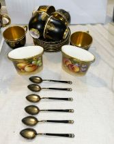 A Royal Worcester set of 6 cabinet cups and saucers with gilt decoration against a black ground; a