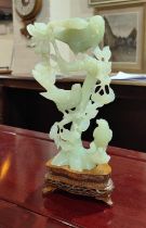 A Chinese jade coloured hard stone carving of three birds sat on branches, well detailed with