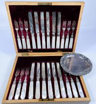 A hallmarked silver set of 12 dessert knives and forks with mother-of-pearl handles, in walnut case,