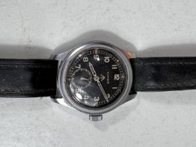 A British military issue wristwatch Timor Dirty Dozen, with black dial and Arabic numerals, military