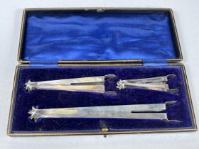 A cased set of three sugar nips, two hall marked silver one unmarked, graduating in size Chester
