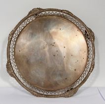 A circular hallmarked silver salver with gadrooned and pierced border on 4 pierced feet, London