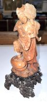 A CHINESE carved soapstone figure of a man, ornate pierced base, 25cm